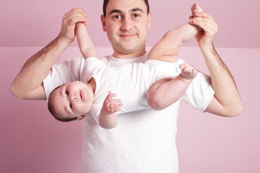 father is doing with baby dynamic gymnastics