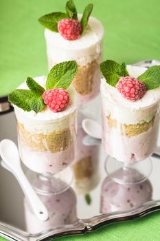 Dessert with raspberry and curd mousse with mint leaves