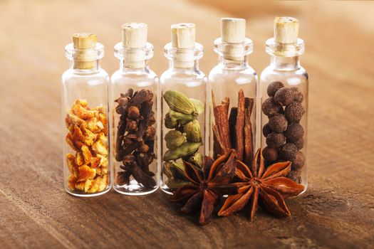 Christmas spices for mulled wine or ginger cookies in small decorative bottles