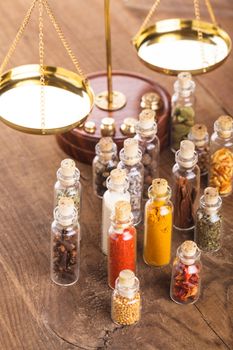 Little bottles with spices and scales on the table, vedic cuisine
