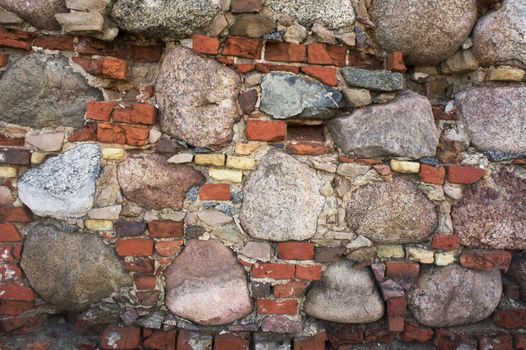 fragment of the old wall of stone and brick