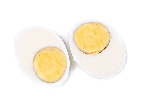 Two halves of a boiled egg. Isolated on a white background.
