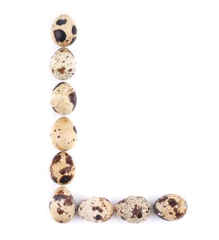 quail eggs in the form of letter L. Isolated on a white background