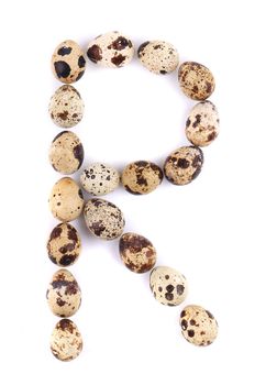 quail eggs in the form of letter R. Isolated on a white background