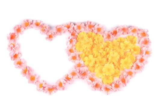 Two hearts made ??of artificial flowers. Isolated on a white background.