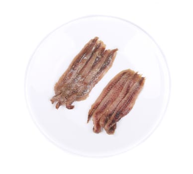 Marinated anchovies on a white plate. Isolated.