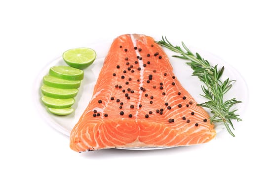Salmon fillet with rosemary and lime. Isolated on a white background.