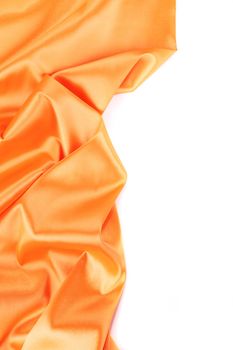 Folds of orange satin. On a white background.