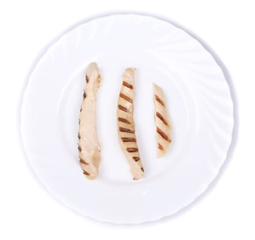 Pieces of grilling meat on a plate. Isolated on a white background.
