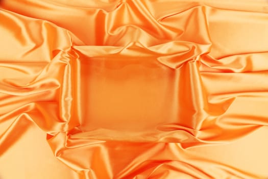 Square in orange fabric. To be used as background.