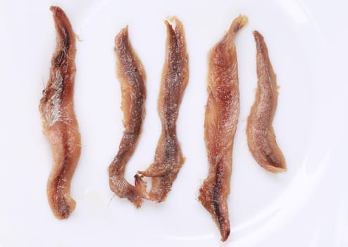 Marinated anchovies. Isolated on a white background.