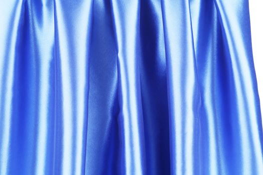 Creases in blue fabric. Isolated on a white background.