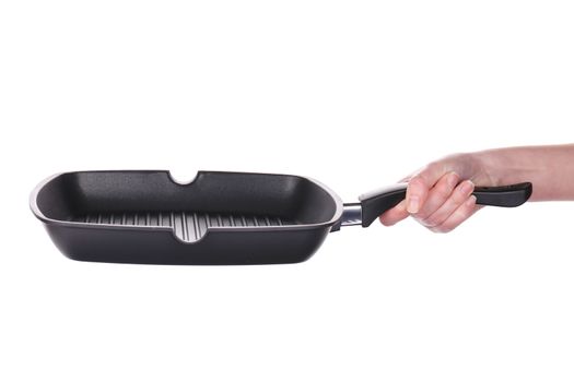 Hand holds a black frying grill pan. Isolated on a white background