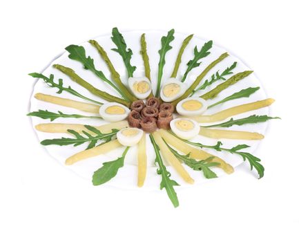 Salad with anchovies and asparagus. On a white background.