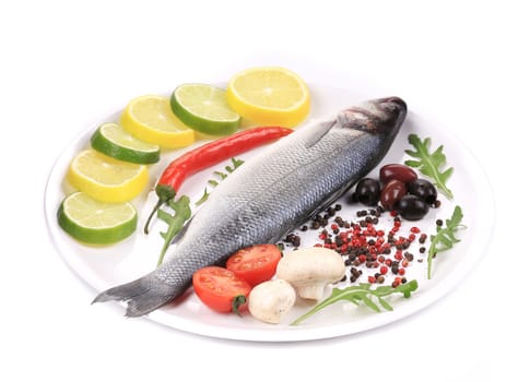 Seabass on plate with citrus and pepper. Isolated on a white background.