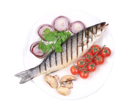 Grilled fish with vegetables. Isolated on a white plate.