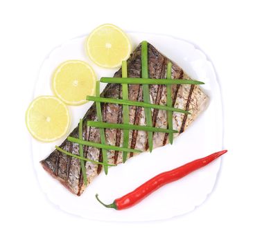 Grilled carp fillet on plate with onion and lemon. Isolated on a white background.