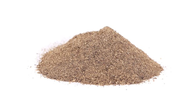 a pilea pile of ground pepper. Isolated on a white background