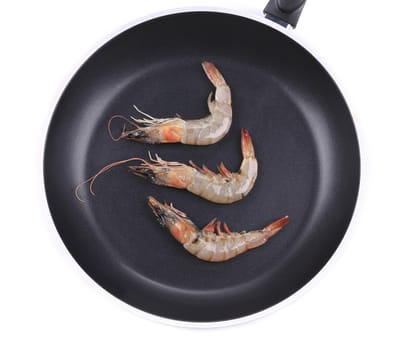 Close up of fresh shrimps on frying pan. Isolated on a white background.