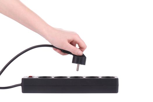 Hand puts the plug in an extension cord isolated on a white background