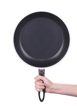 Hand holds a black frying pan. Isolated on white background