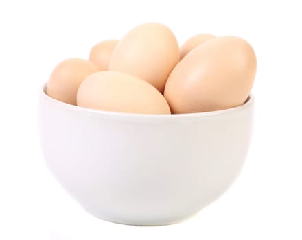 Bowl with brown eggs. Isolated on a white background.