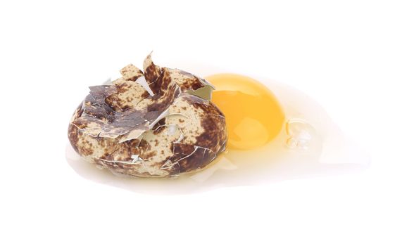 raw broken quail egg. Isolated on a white background