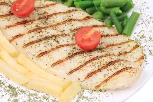 close up of Pangasius fillet grilled with vegetables. Isolated on a white background.