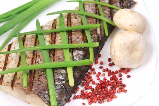 Grilled carp fillet on plate with onion. Whole background.