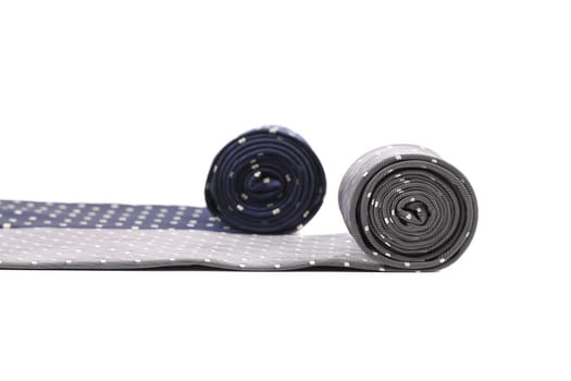 Rolled up two man's ties. Isolated on a white background.