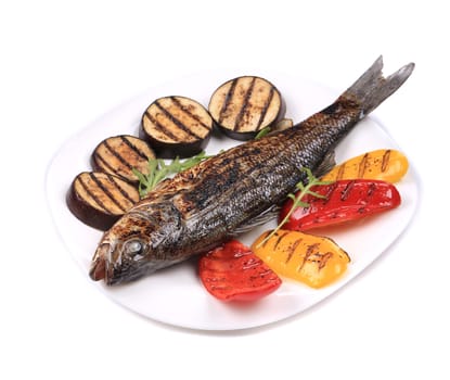 Grilled seabass with vegetables on plate. Isolated on a white background.