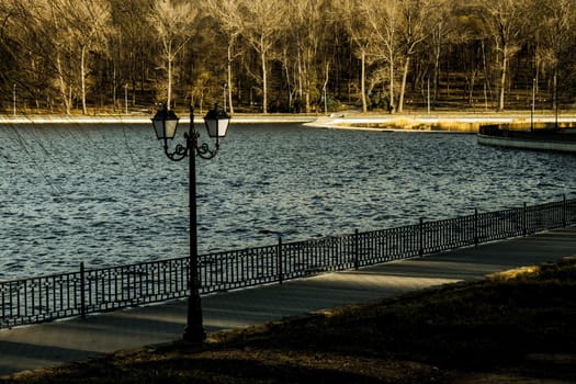 pier with lanterns on the autumn lake