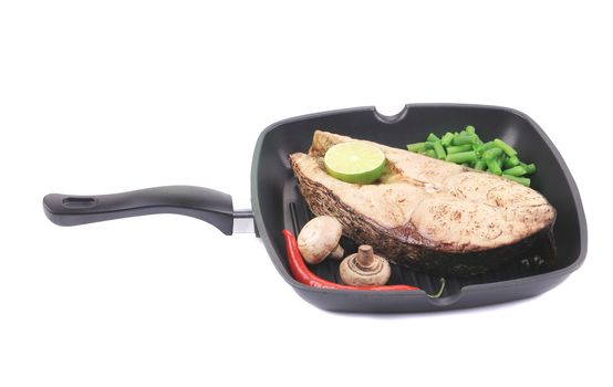 Grilled carp steak on pan. Isolated on a white background.