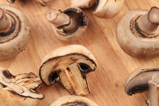Mushrooms on wooden platter. Close up. Whole background.