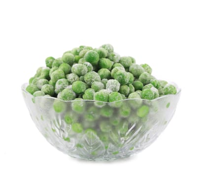 Glass dish with green frozen peas. Isolated on a white background.