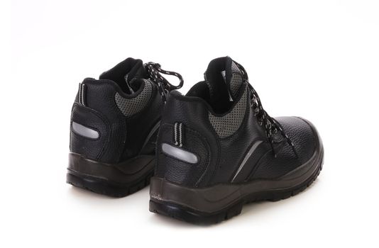 Close up of black shoes with gray spot. Isolated on a white background.