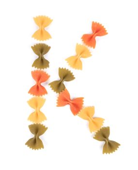 Letter K from the colorful pasta. Isolated on a white background.
