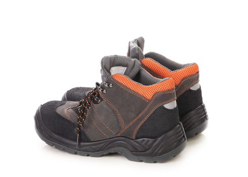 Pair of black and orange men boots. Isolated on a white background.