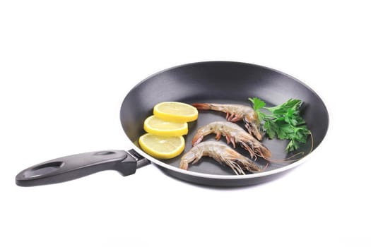 Fresh shrimps on pan with lemon. Isolated on a white background.