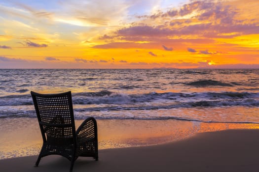Beach chair on sand beach for relaxing in sunset