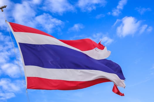 defective waving flag of Thailand and blue sky background
