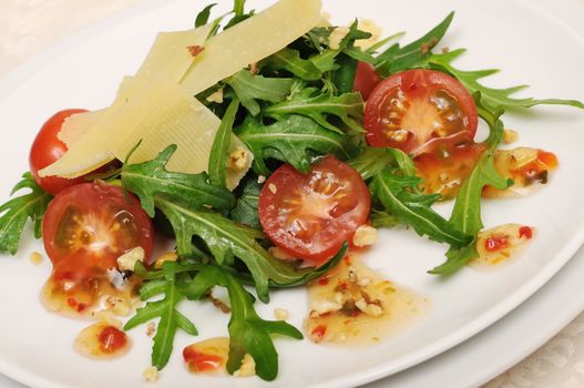Spicy salad of arugula and cherry tomatoes with parmesan sauce