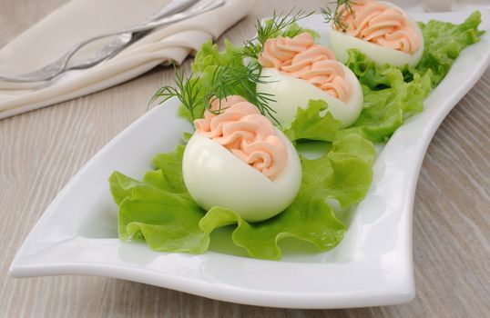Eggs stuffed with salmon pate in lettuce leaves