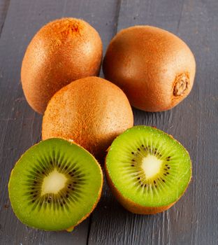 A bunch of kiwis over grey wooden background