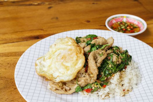 Thailand traditional food, spicy basil fried rice with pork and chilli fish sauce