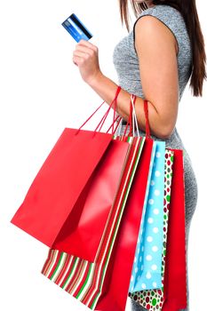 Cropped image of a young woman holding shopping bags