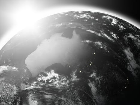 Space view of the sun rising over Australia on black planet Earth. Elements of this image furnished by NASA.