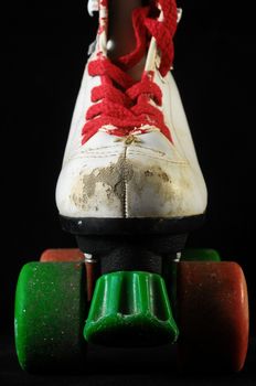 Used Vintage Consumed Roller Skate on a Black Background