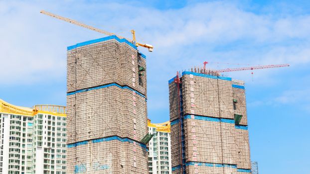 building under construction site and blue sky, wrap for safety