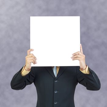 Business man holding blank sign or present showing over head